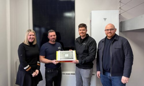 A photo showing Infinity Energy Services and Tesla Energy staff celebrating the milestone of having installed 1,000 Tesla Powerwall batteries.