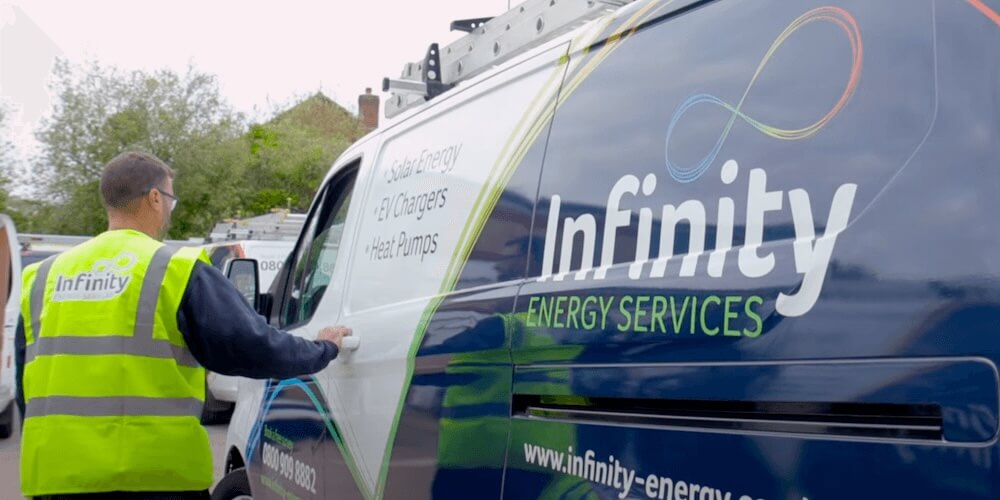 An Infinity Energy Services engineer installing a Sigenergy SigenStor system at a Wiltshire property