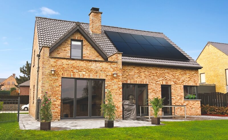 A completed solar PV system on a Woodley home with a clear view of the panel array and surrounding neighbourhood
